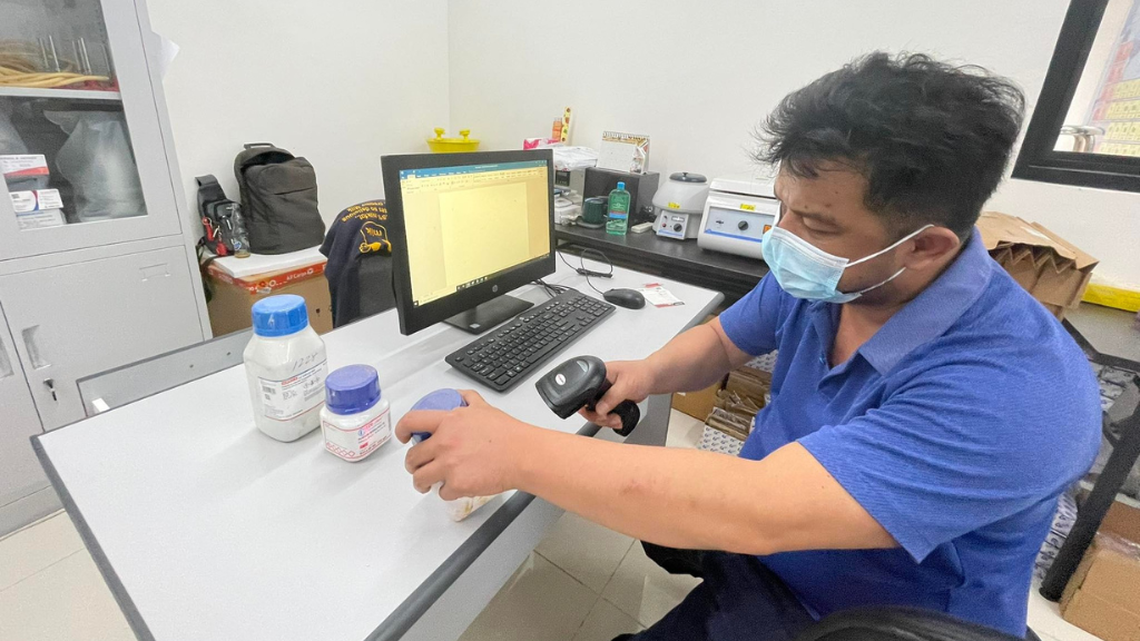 Man labeling chemicals in lab